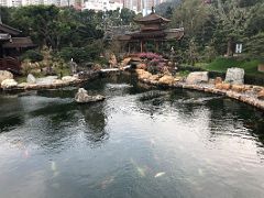 11A The Pavilion Bridge at the end of a small pond with rocks dotting the shore in Nan Lian Garden Hong Kong